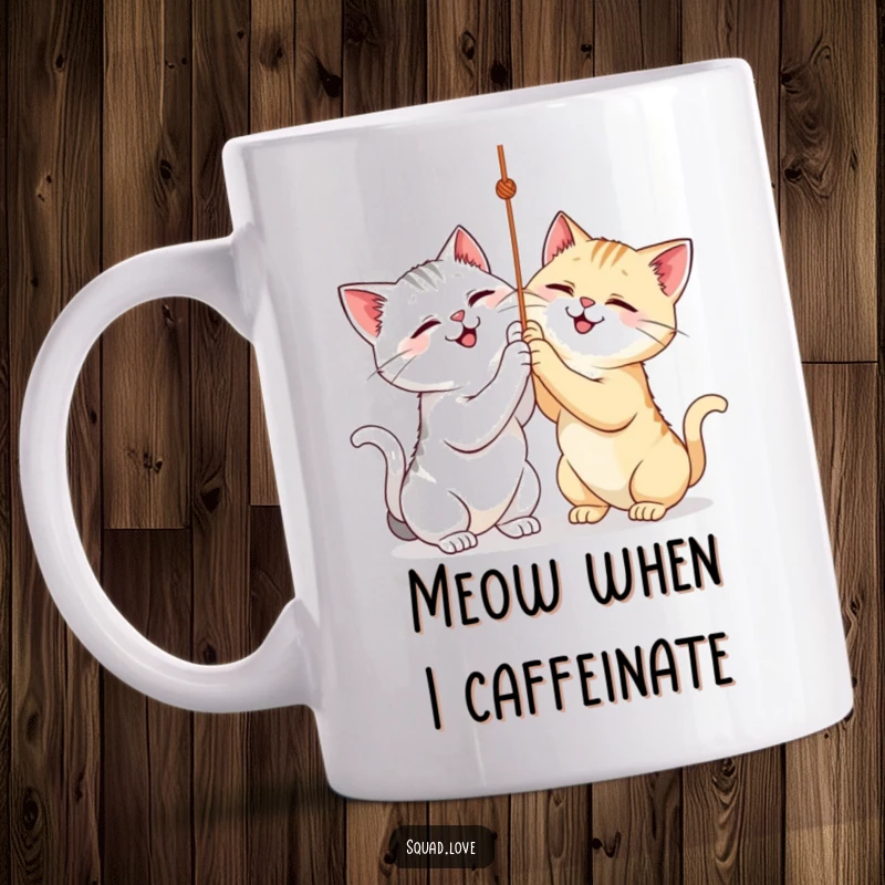 Funny mug showing two smiling cats gleefully batting at a dangling string, full of playful energy. A great gift.