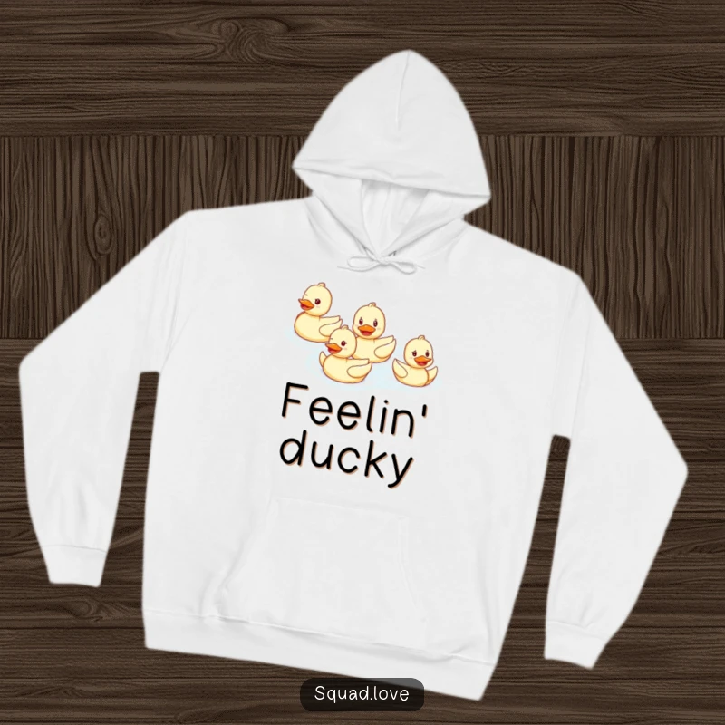 Funny hoodie depicting a smiling duck family swimming in perfect formation, offering warmth and cheerful synchronized aquatic fun.