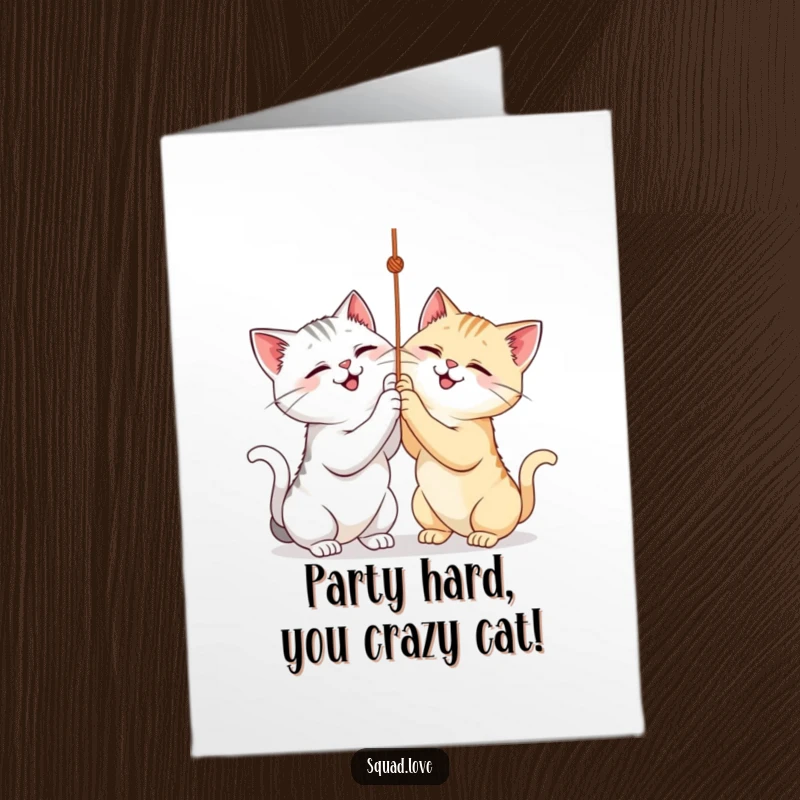 Funny Free Printable Birthday Card with two smiling cats playfully batting at a dangly string, capturing pure feline mischief.