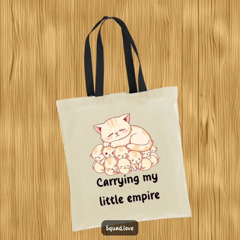 Funny tote bag depicting a peaceful cat napping atop a fluffy mound of cheerful, snoozing kittens, a charmingly humorous accessory.